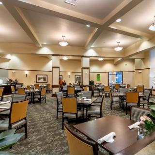 Spacious dining hall with neatly arranged tables and chairs.