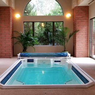 A luxurious indoor pool with modern design and large windows, perfect for relaxation.