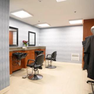 A modern hair salon with styling stations and chairs.