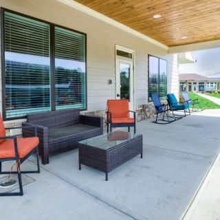 Modern patio area with seating and large windows.
