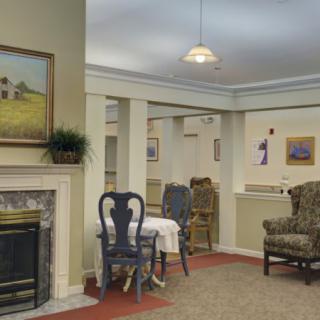 A cozy living room with a fireplace, painted walls, and comfortable seating arrangements.