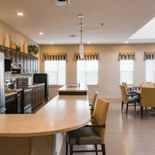 A modern kitchen and dining area with neutral tones and contemporary design.