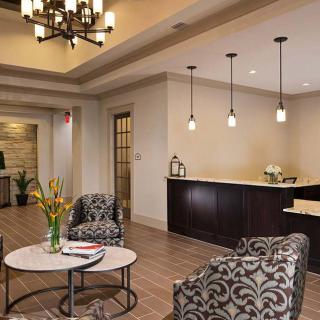 A modern lobby with a seating area, featuring elegant furniture and stylish lighting fixtures.