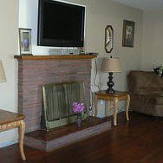 A cozy living room with a fireplace, television, and comfortable seating.
