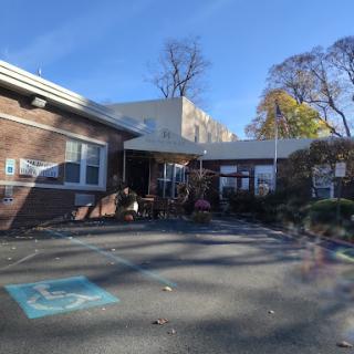 A sunny day at a school, featuring a playground and a welcoming atmosphere.
