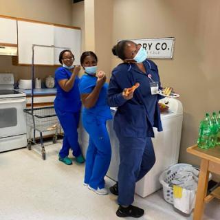 A cheerful team of nurses posing together in their scrubs, showcasing teamwork and camaraderie in a healthcare setting.