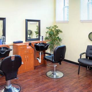 A bright and tidy hair salon interior with styling chairs and mirrors.
