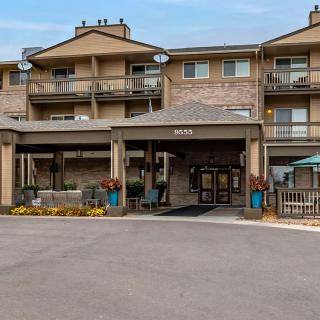 Exterior view of a hotel building with an entrance area and multiple balconies.