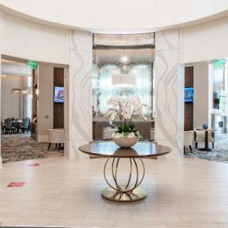 A modern hotel lobby featuring elegant decor and a stylish centerpiece.