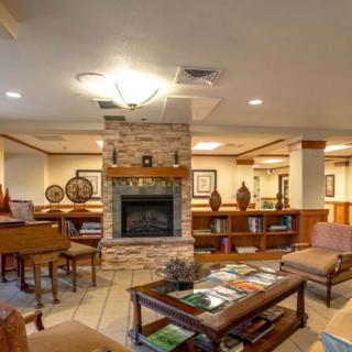 A cozy lounge area featuring a fireplace and comfortable seating.