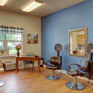 A hair salon interior with hairstyling stations and a waiting area.