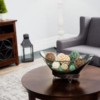 A modern living room with a decorative bowl on a wooden coffee table.