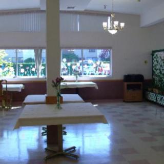 An empty dining area with tables, chairs, and large windows.