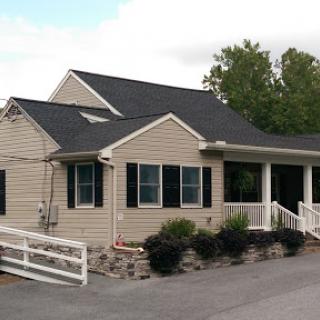 A charming suburban house with a neatly landscaped yard.