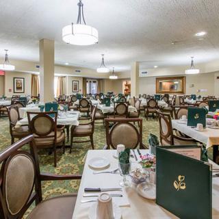 An elegant restaurant dining room with neatly arranged tables and chairs, ready for guests.