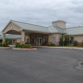 A view of a hotel entrance on a cloudy day.