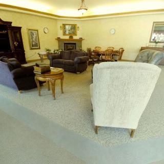 A cozy living room with sofas, chairs, and a fireplace.
