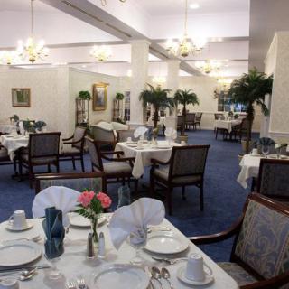 An elegant restaurant dining room with neatly set tables and classic decor.