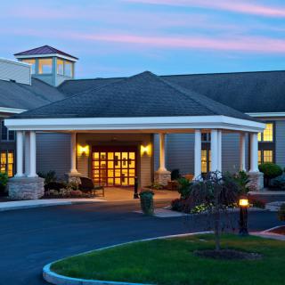 A cozy hotel entrance illuminated during the evening.
