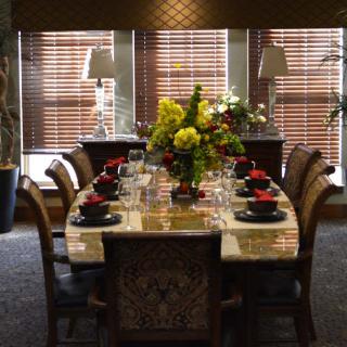 A beautifully set dining table with floral centerpieces and elegant decor.