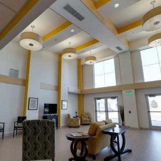 A spacious and modern lobby area with high ceilings, comfortable seating, and large windows allowing natural light.