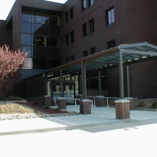 View of a modern building entrance with landscaped surroundings.
