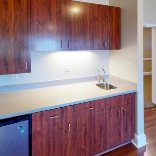 A modern kitchen with wooden cabinets and a sleek countertop.