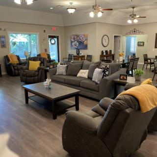 A spacious and cozy living room with modern furniture and decor.