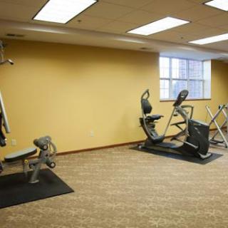 A well-equipped indoor gym featuring various exercise machines.