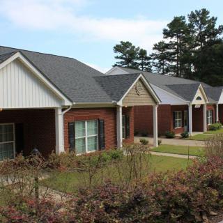 A row of suburban houses with well-maintained lawns.