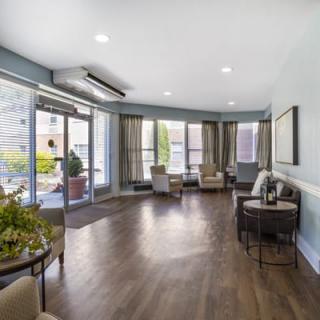 A spacious lobby with comfortable seating and large windows allowing natural light to fill the room.