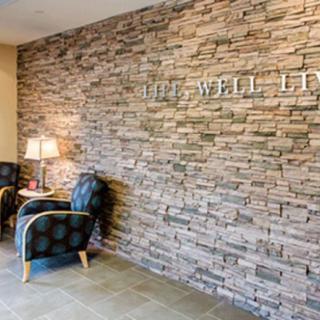 A cozy waiting area with a brick accent wall and comfortable seating.