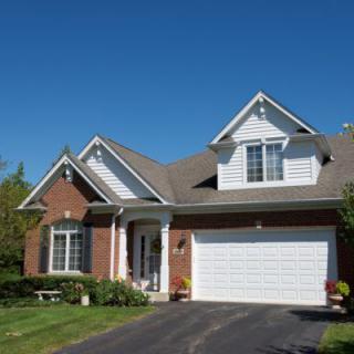 A suburban house with a garage and well-kept front yard.