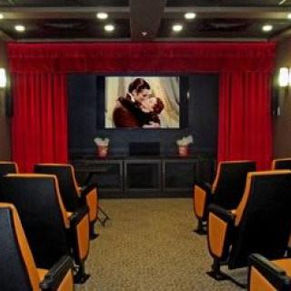 A cozy home theater with a large screen and comfortable seating.