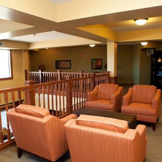 A cozy lounge area with comfortable seating arrangements and warm lighting.