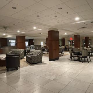 A spacious and elegantly designed hotel lobby featuring comfortable seating arrangements.
