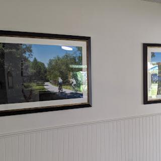 Two framed landscape photographs hanging on a wall.