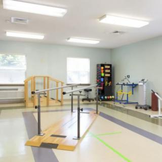A physical therapy room equipped with exercise and rehabilitation tools.