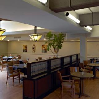 A cozy restaurant dining area with tables and chairs arranged for patrons.