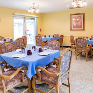 A cozy dining area featuring blue tables and elegant seating, perfect for gatherings.