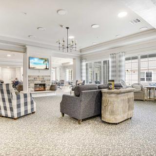 A spacious and well-lit living room with modern furniture and decor.