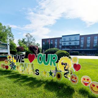 A vibrant display of appreciation with colorful decorations on the lawn.