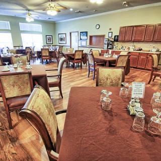 A dining area with neatly arranged tables and chairs, ready for guests.