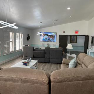 A modern living room with comfortable sofas and a mounted television.