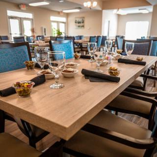 A well-set dining table in a restaurant with elegant glassware and cutlery.