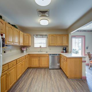 A spacious kitchen with wooden cabinets and modern appliances.