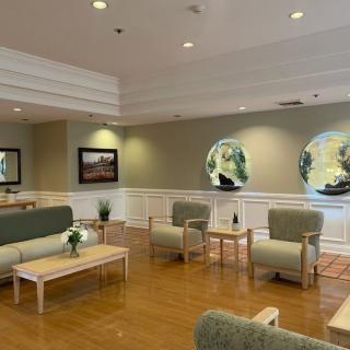 A modern and comfortable lobby area with seating and large circular windows.