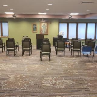 A room arranged with chairs facing a podium, suitable for meetings or gatherings.