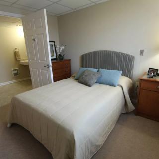A cozy bedroom with a neatly made bed and bedside tables.