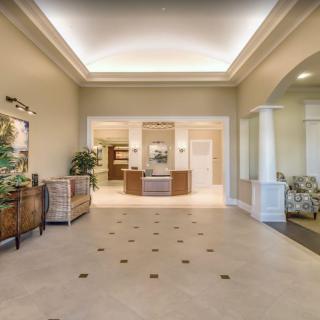 A spacious and elegantly designed lobby with decorative furniture and soft lighting.